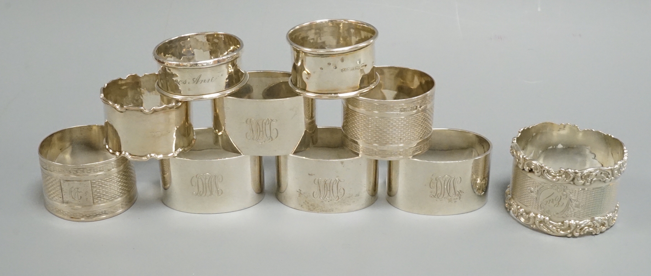 A set of four George V silver oval napkin rings, Mappin & Webb, London, 1925 and six other assorted silver napkin rings.